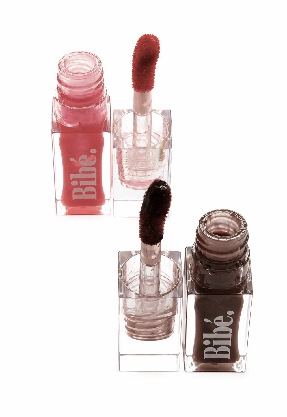 Two Bibé lip oil bottles with applicator wands