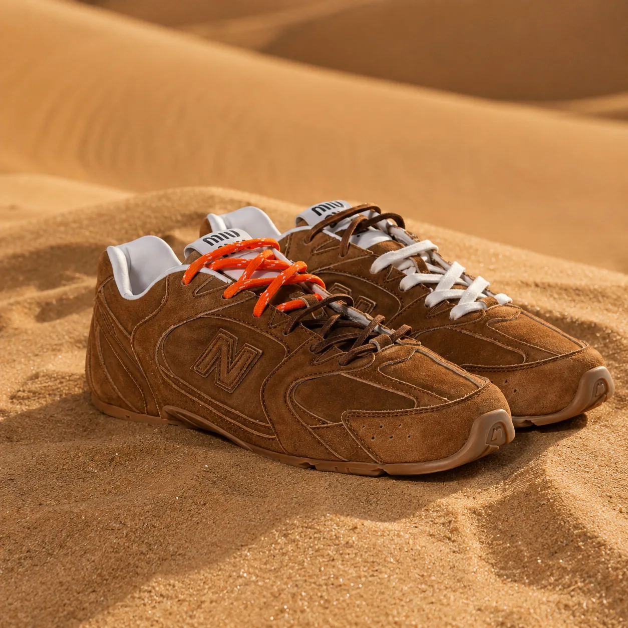 Miu Miu x New Balance sneakers styled on a dune